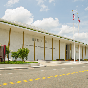 Blue skies with few clouds over the white stone John F. Kennedy Memorial Center for The Performing Arts.